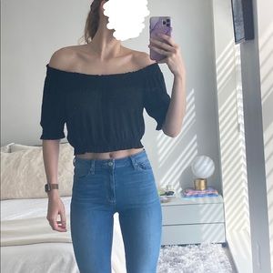 Black cropped top with cinched waist and sleeves